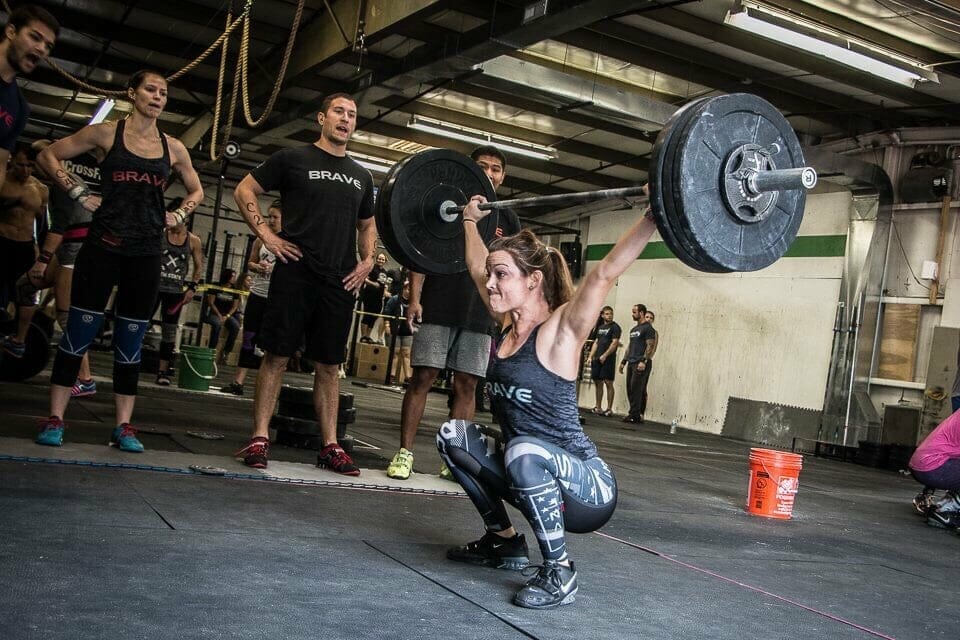 crossfit woman doing snatch olympic lift