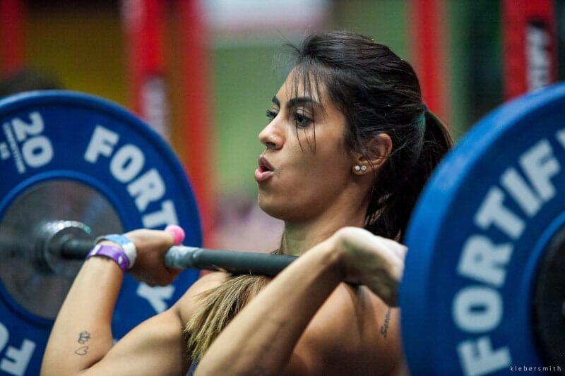 woman with barbell on shoulders