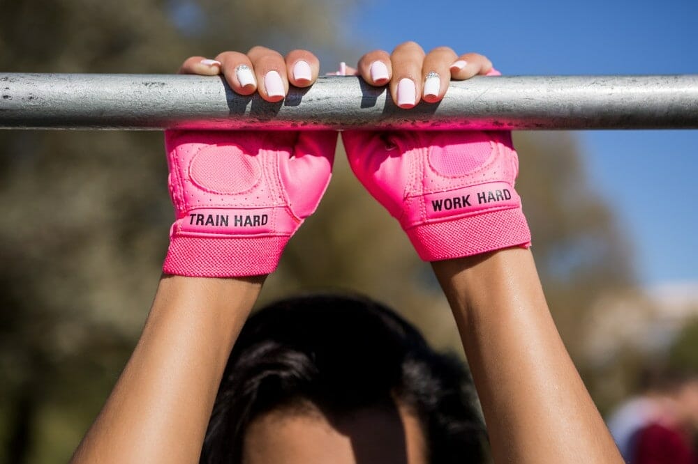 Woman using CrossFit Gloves with bar