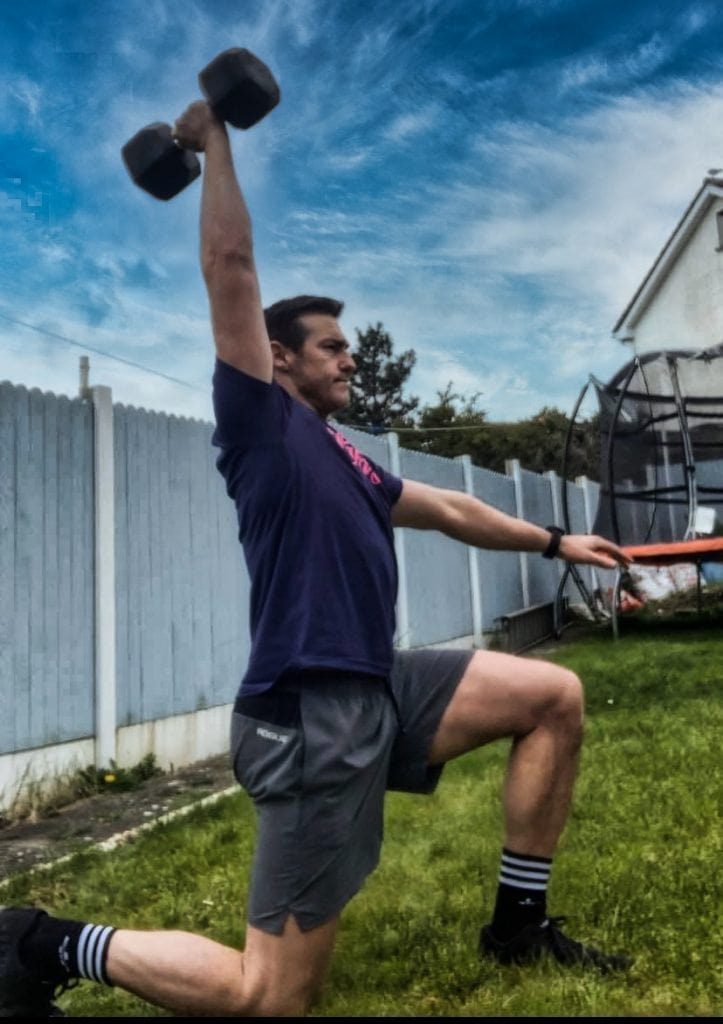 Lunge Position Of Overhead Dumbbell Walk