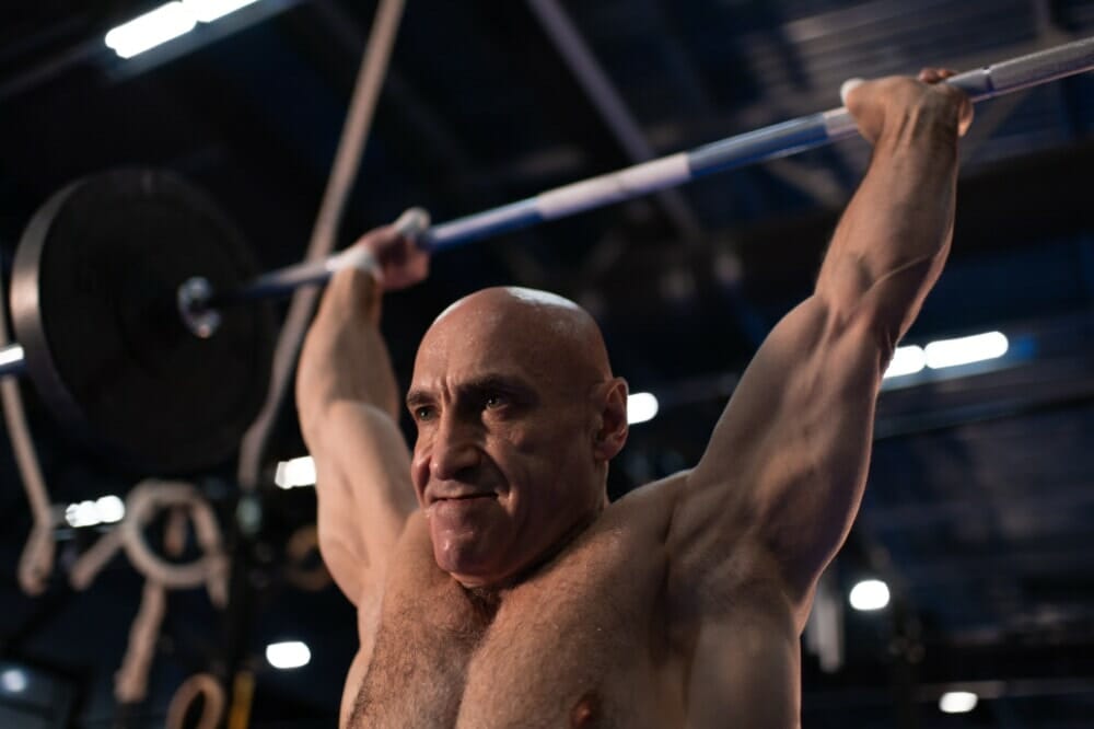 Sweaty Elderly Sportsman Lifting Barbell